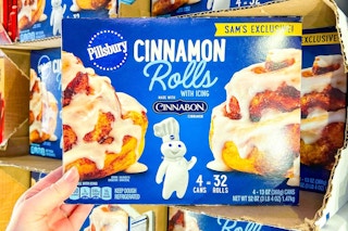 hand holding a box of pillsbury cinnamon rolls