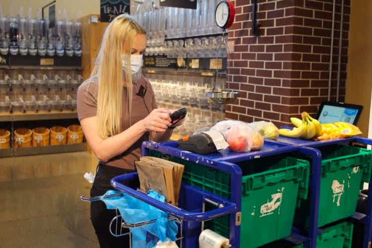 A employee preparing grocery pickup orders.