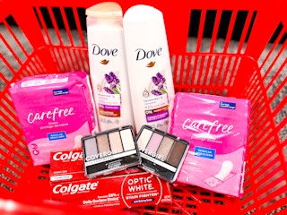 Carefree liners, Covergirl eyeshadow, Dove shampoo and conditioner, and Colgate toothpaste in shopping basket