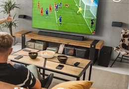 people watching soccer with a Philips sound bar, subwoofer, and surround sound speakers