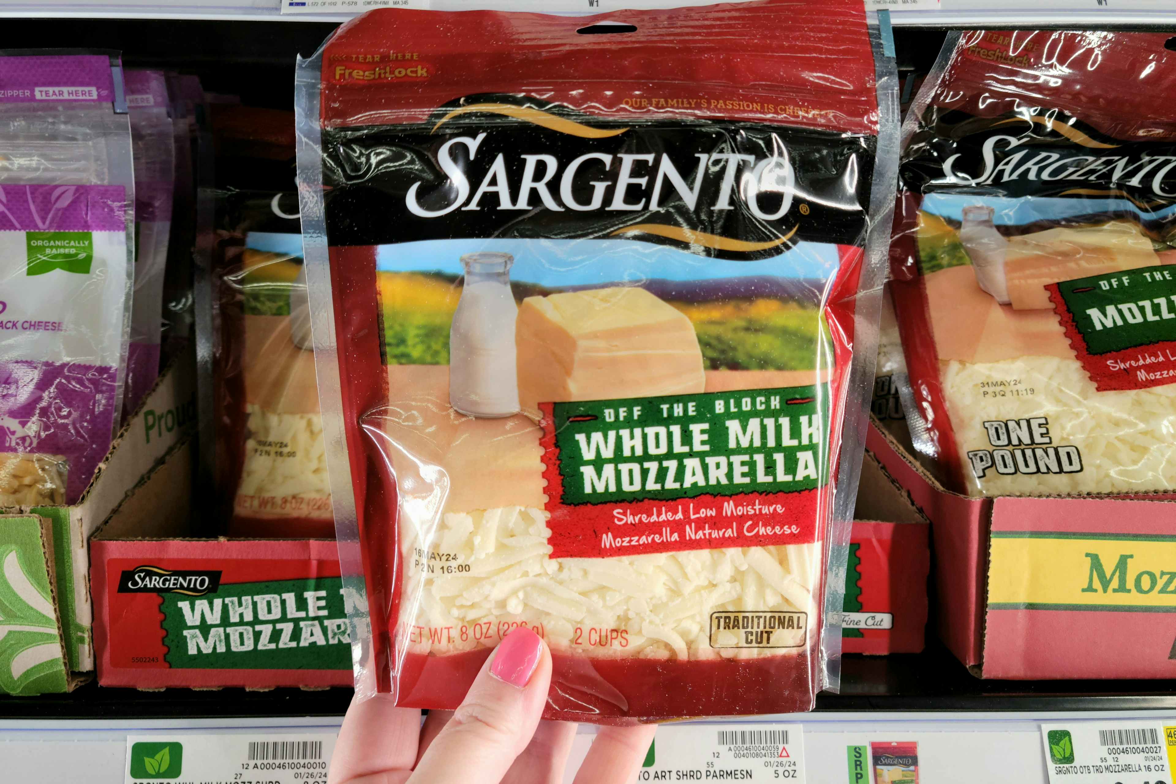 hand holding sargento shredded cheese