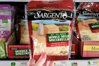 hand holding sargento shredded cheese