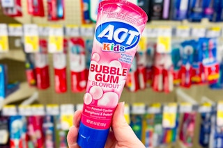 hand holding a tube of act bubblegum kids toothpaste
