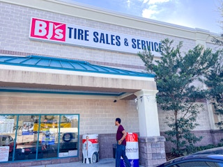 Person walking into Bj's Tires