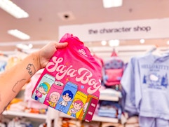 hand holding a kpop demon hunters kids tee in front of target apparel