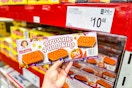hand holding a box of little debbie pumpkin brownies