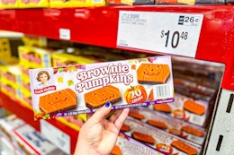 hand holding a box of little debbie pumpkin brownies