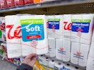 hand holding walgreens brand toilet paper and paper towels on shelf