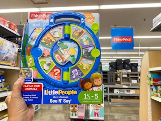 hand holding fisher price little people world of animals see n say at walmart