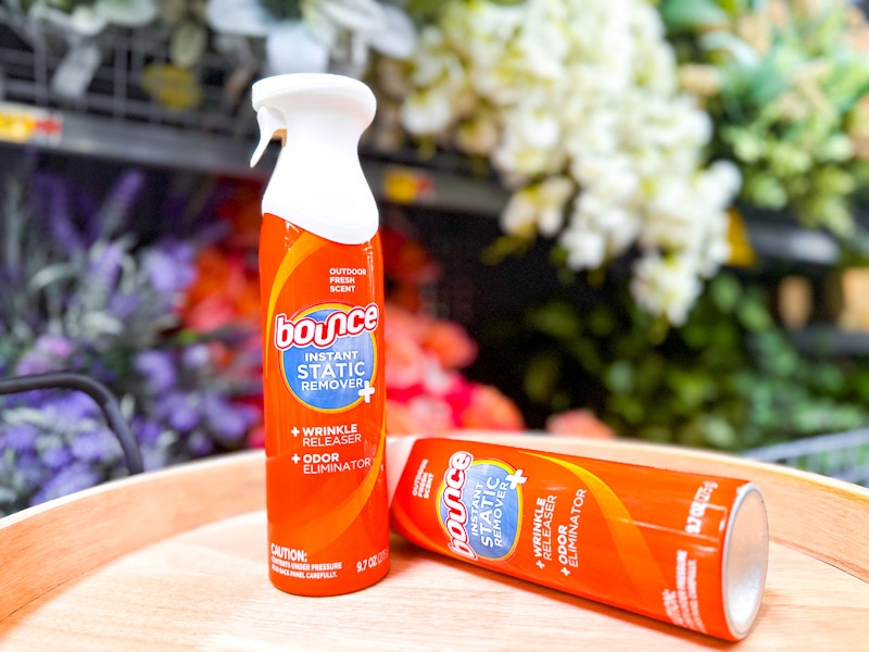 Two Bounce Anti-Static Sprays on wooden tray in front of floral arrangements at Walmart