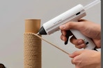 hot glue gun being used on twine