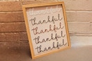 Lifestyle image of the 8x10 Way to Celebrate Thankful decor with brick wall in the background
