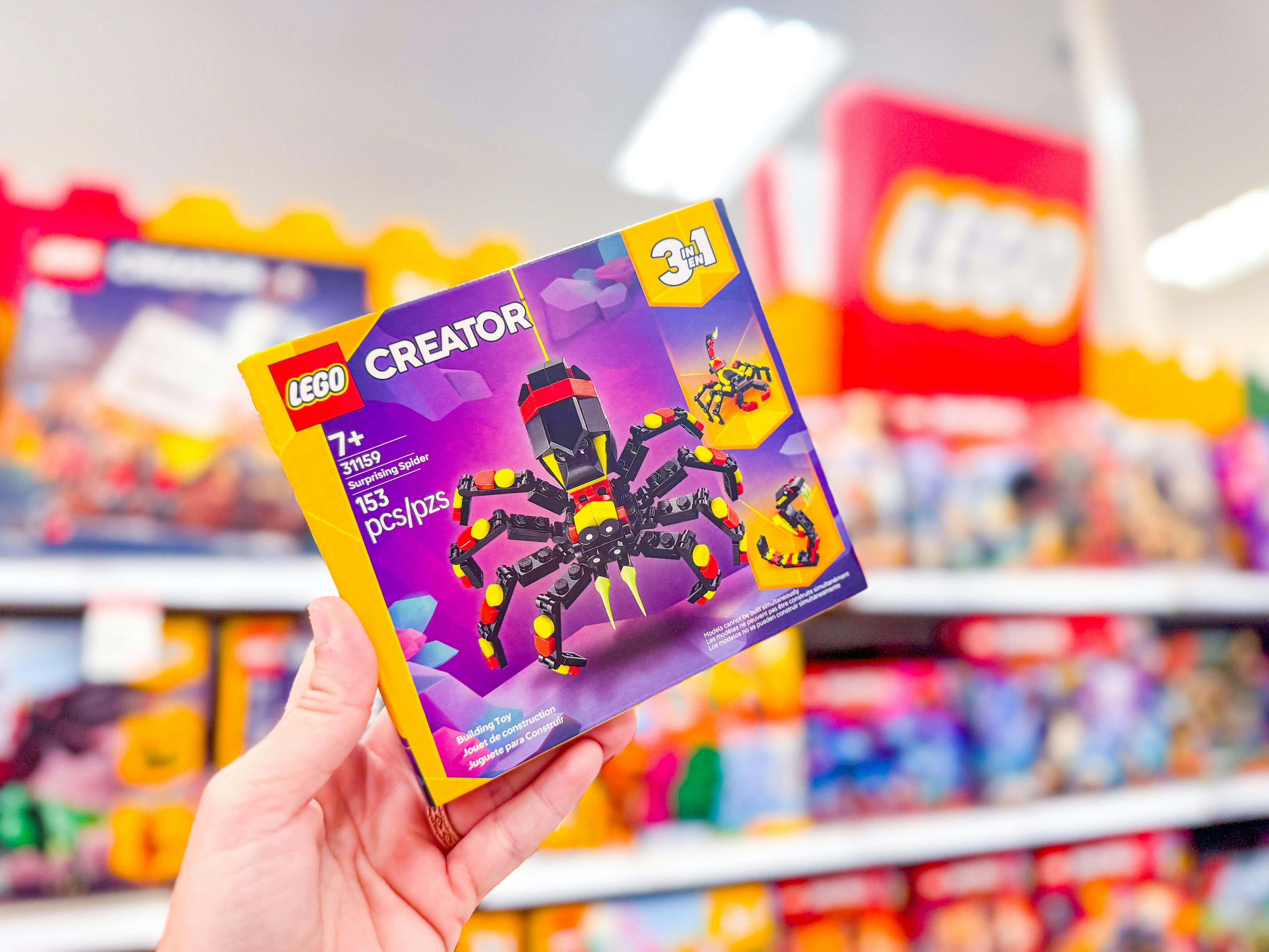 hand holding a lego spider set at target