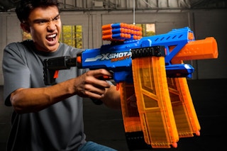 Teen using XSHOT Insanity Motorized Clip Mania Dart Blaster.
