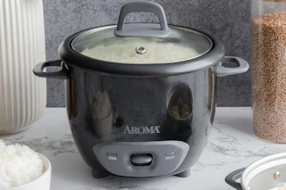 an aroma rice cooker on a table