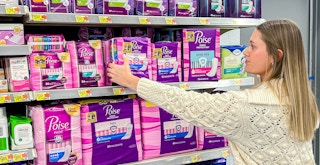 a person reaching for poise pads in walmart