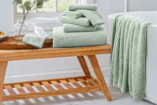 Lifestyle image of the pale green Jessy Home Oversized Bath Towel Set in bathroom setting