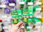 Hand holding scotch tape