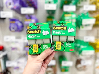 Hand holding scotch tape