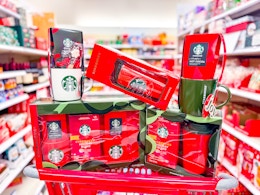 five starbucks gift sets piled on top of target cart in aisle