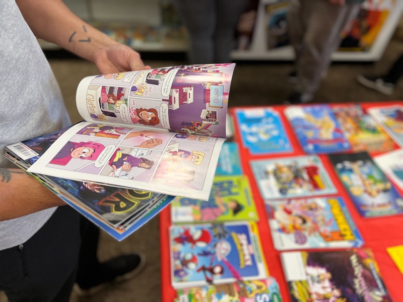 A man flips through one of the issues offered on free comic book day