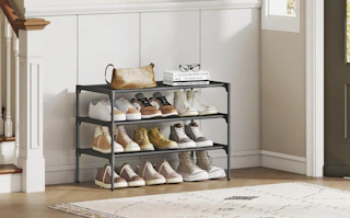 a shoe rack with shoe in a house's entryway next to a front door