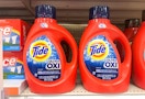 two large bottles of tide ultra oxi liquid laundry detergent on a shelf