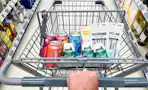 hand pushing a cart full of walgreens groceries