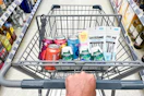 hand pushing a cart full of walgreens groceries