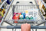 hand pushing a cart full of walgreens groceries