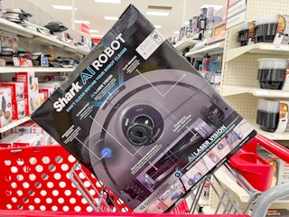 A Shark AI Robot sitting in a store cart.