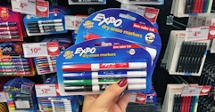 hand holding expo dry erase markers at staples