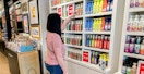 A woman looking at products in a Bath and Body Works store.