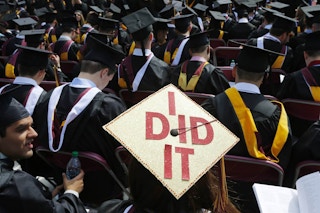 Crowd of new graduates one hat reads, "I did it"