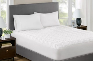 a mattress pad on a bed