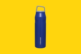 a stanley water bottle on a yellow background