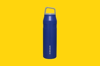 a stanley water bottle on a yellow background