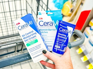 hand holding cerave products over walgreens cart