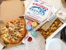 a domino pizza dinner layed out on a counter
