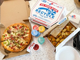 a domino pizza dinner layed out on a counter