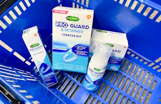 polident proguard and retainer cleansers in a blue walmart basket