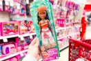 hand holding a Moana Disney fashion doll in the toy aisle