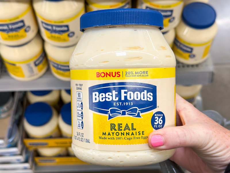 hand holding a jar of best foods mayonnaise in front of display at walmart