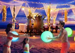 a family playing with glowing beach balls on a beach