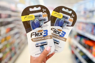 hand holding two packs of BIC Flex3 Razors in aisle