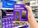 hand holding a roku express device