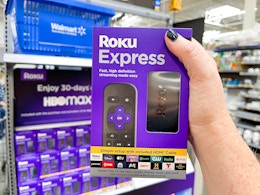 hand holding a roku express device