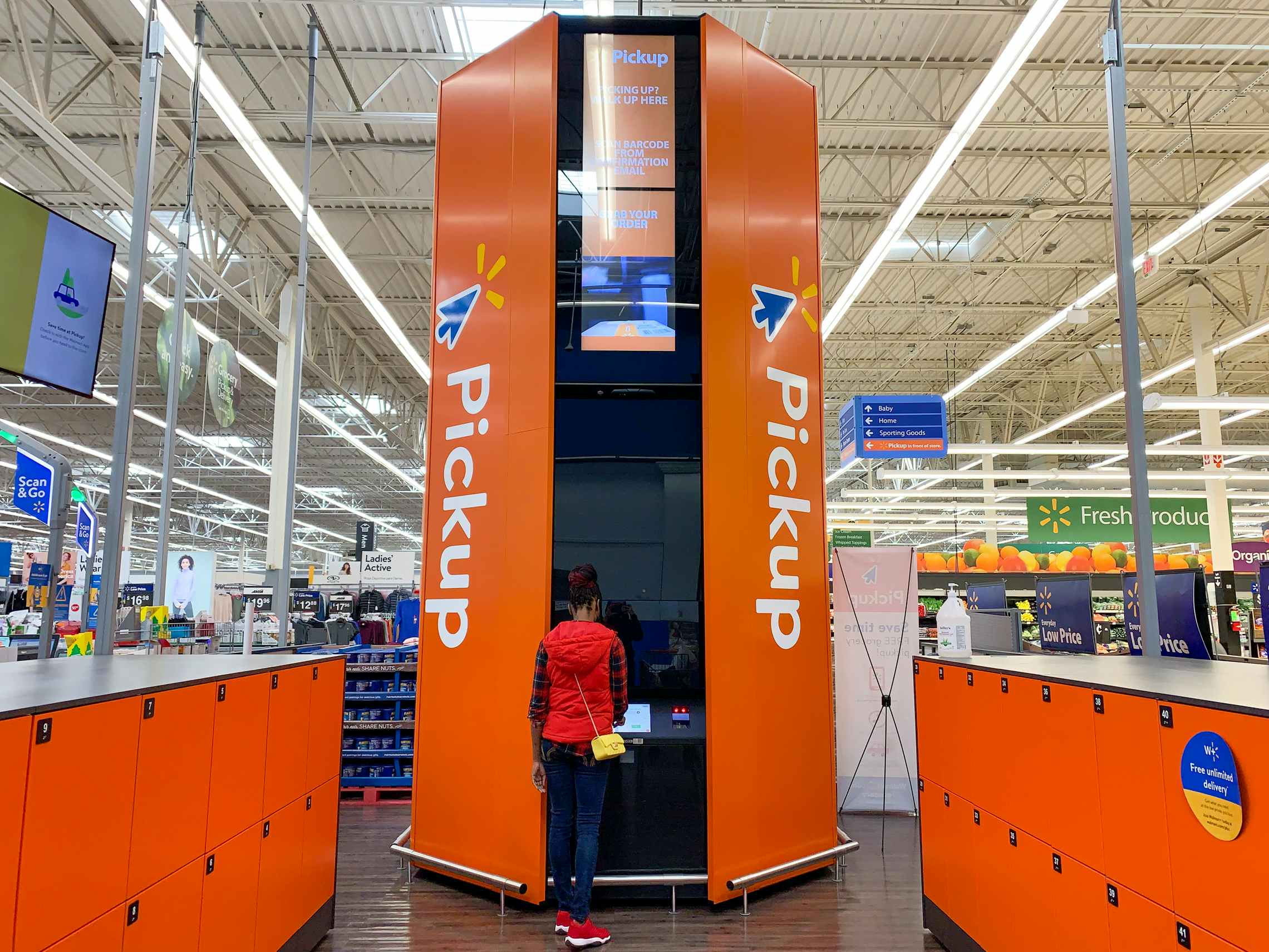 person standing at walmart in-store pickup order tower