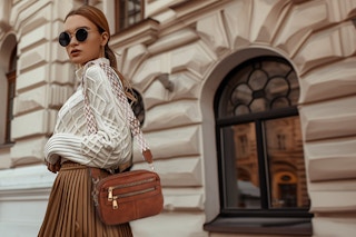 a woman wearing a crossbody bag