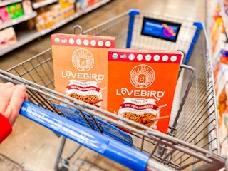 hand pushing cart with two lovebird cereals